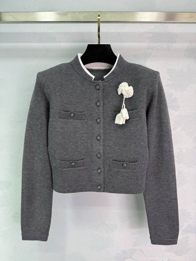 Sp This gray Chanel-inspired wool knit cardigan features delicate white floral e