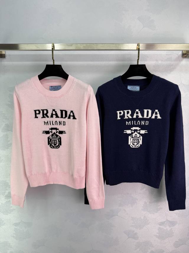 Prada knitted sweater, available in pink and navy, features embroidered Prada lo