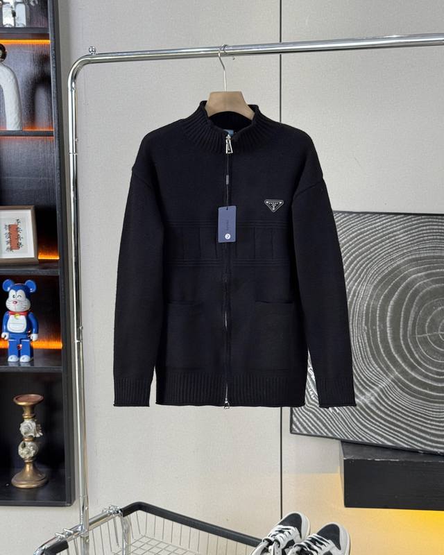 This classic Prada sweater features a double zipper and a stand-up collar. This