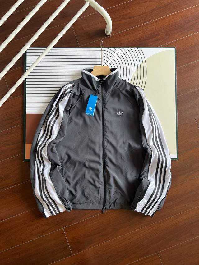 Adidas stand-up collar, double-sleeved zippered three-stripe jacket. This classi
