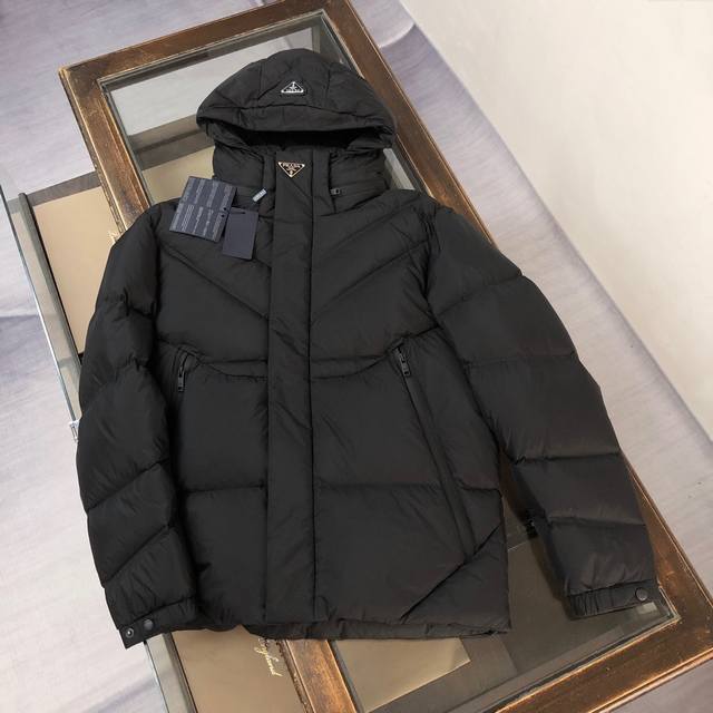 pra*Da Prada's latest Autumn/Winter 2025 triangular metal iron label hooded down
