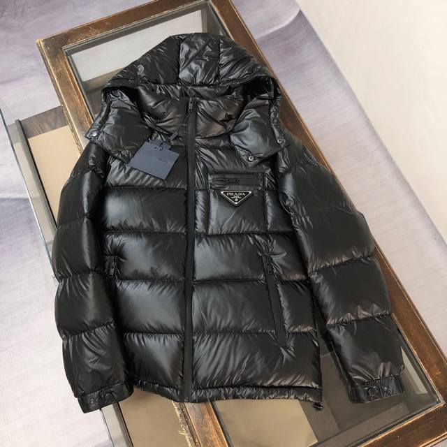 Prada's latest fall/winter glossy down jacket! The front chest pocket features