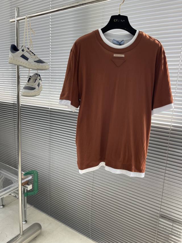 prad 25Ss's new T-shirt gives a wardrobe staple a new twist through layering. Th