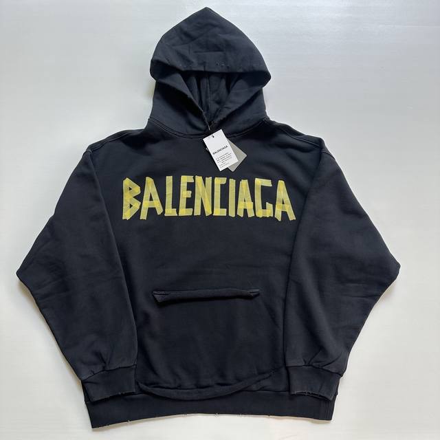 Balenciaga's distressed, washed, and faded masking paper printed lettering hood
