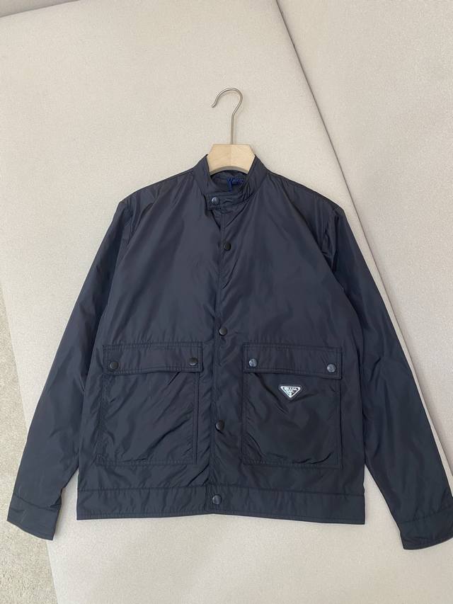 Prada25 metal micro-logo stand-up collar jacket. This jacket is made of recycle