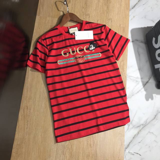 Gucci's popular striped print features a cute and playful Mickey Mouse patch. 20