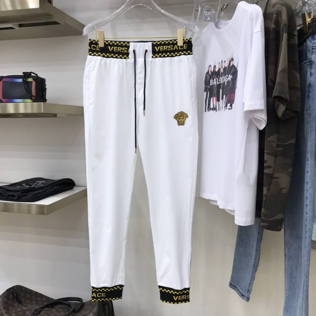 Versac's trendy Medusa logo casual trousers. Custom-made woven fabric offers a
