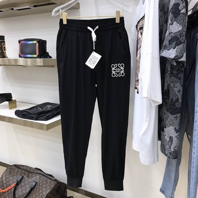 Loew brand logo casual trousers are custom-made from original fabric with a sup