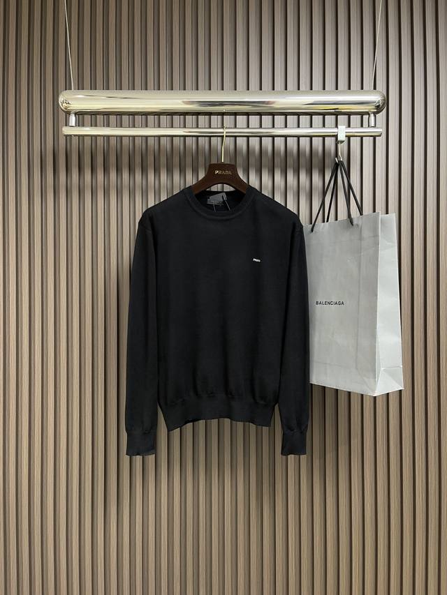 Prada small letter embroidered knit sweater, made from 80% wool and 20% cotton.