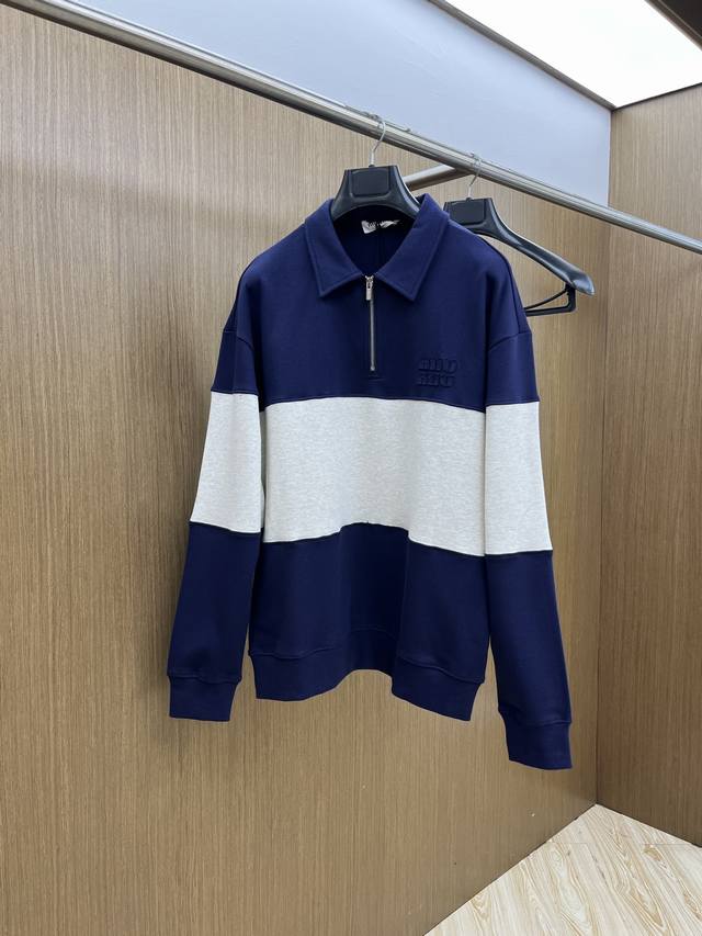 Miumiu's 2025 Fall/Winter half-zip sweatshirt features a navy and light grey pat