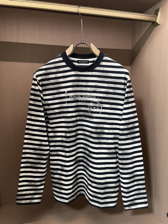 This Maison Margiela distressed striped long-sleeve top is a niche fashion state