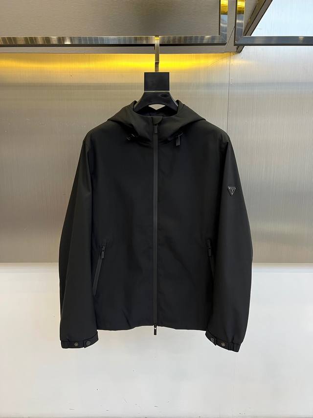 Prada's new hooded jacket for Fall/Winter 2025 embodies a modern, utilitarian a