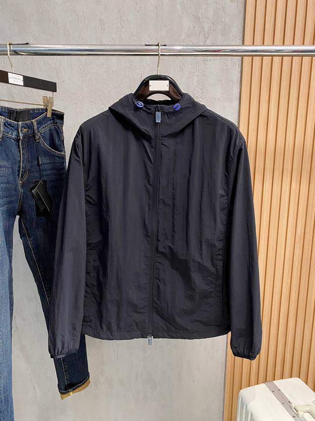hooded jacket, crafted from lightweight nylon fabric. The back is embroidered w