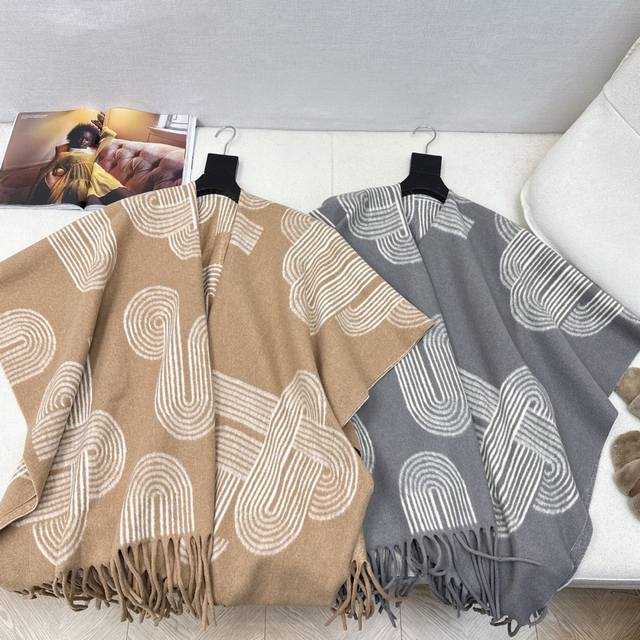 Her 25Ss' latest fall/winter classic woven cape and shawl coat. Hand-piped edges