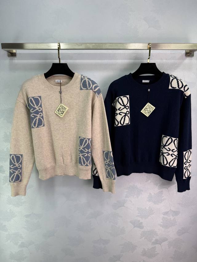 Loe*25's new early fall knit top features a classic logo patchwork design. The w