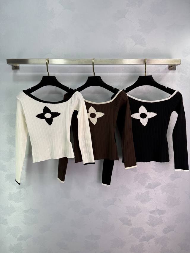 Lou*25's new early fall four-leaf clover knit top features a four-leaf clover em