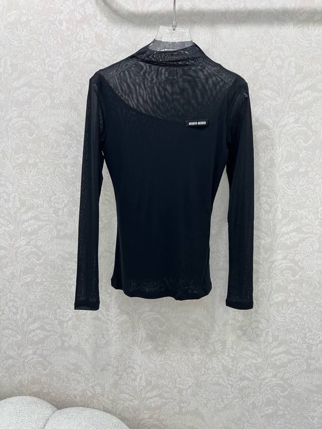 Miumi*25's new mesh-trimmed top with a slightly piled collar and a classic logo