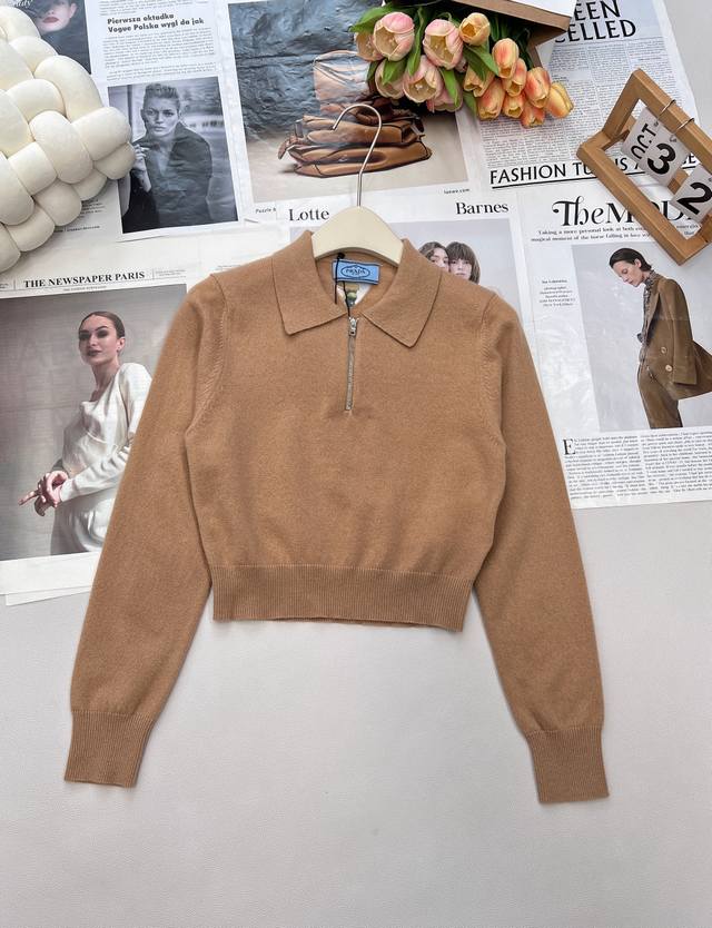 Prada's new early fall knit top features a cutout triangle logo on the back. It
