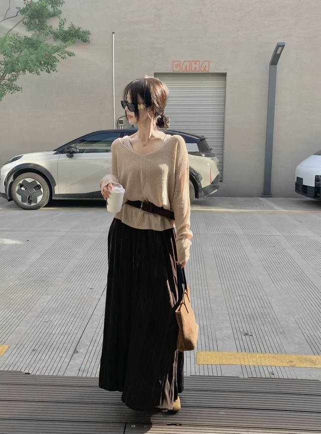 This niche design of a hollowed-out light camel knit top, vest, belt, and skirt
