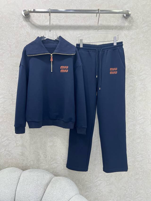 Miumi*25's new ensemble features a ribbed lapel, half-zippered sweatshirt, and s