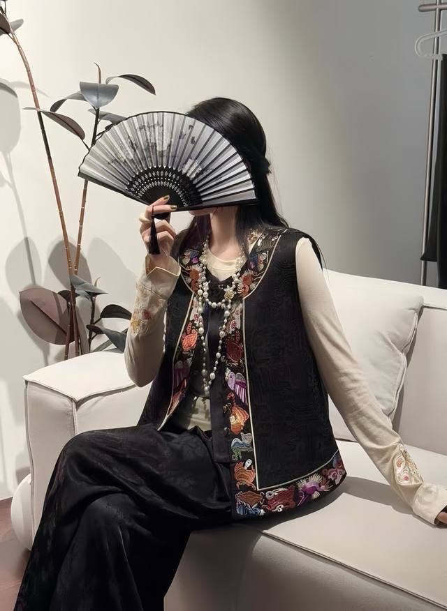 Heavy-duty retro Chinese embroidered vest with rich colors and layered textures.