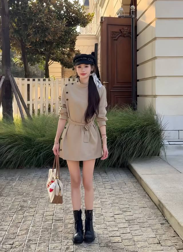 Elegant and sophisticated, this khaki trench coat with a waist belt is soft and