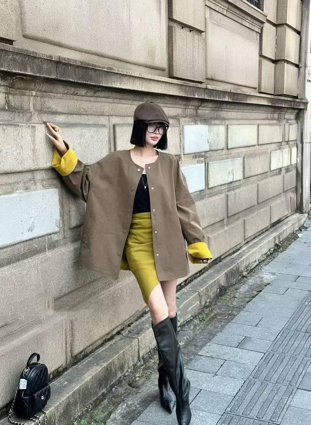 New for early fall, this tie-neck cape trench coat features a loose cape silhou