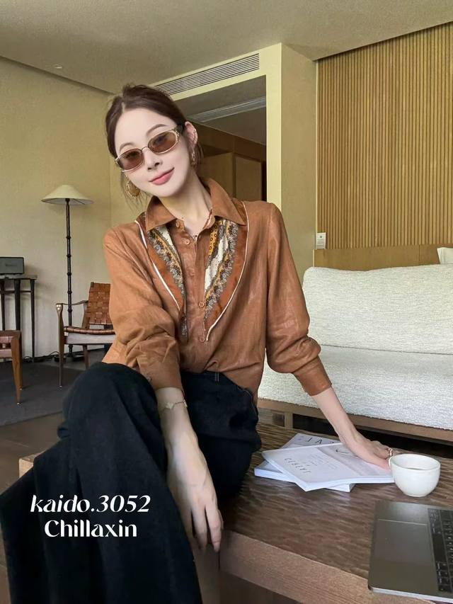 It is so stylish. The simple and casual shirt is paired with a printed silk sca