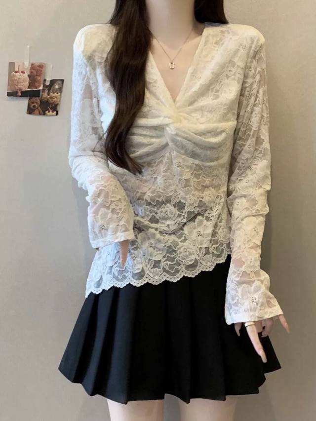 This pure, sensual, knotted lace blouse features a delicate, luxurious feel, an