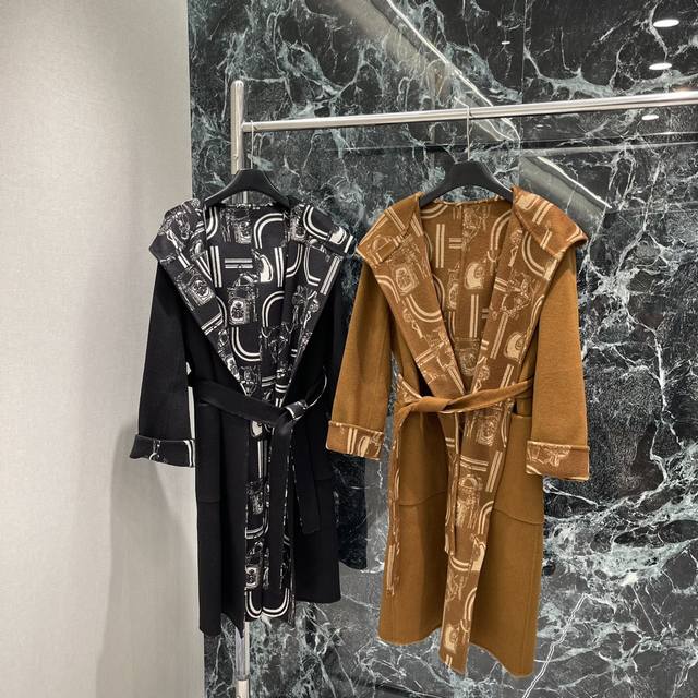 Her 25 Early Fall new hooded, monogrammed long knitted coat. The heavily crafte