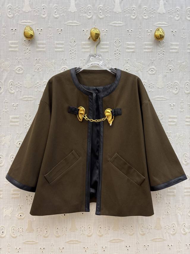 Sch 25 Autumn round-neck jacket with metal ear buckles. A clash of retro and mod