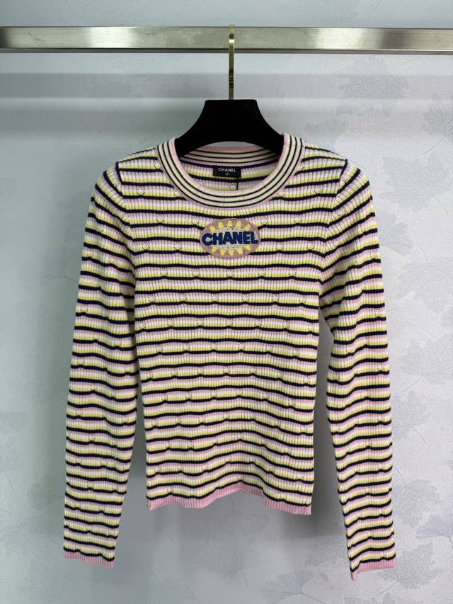 Chane striped sweater, featuring pink, yellow, and black stripes, and embroidere