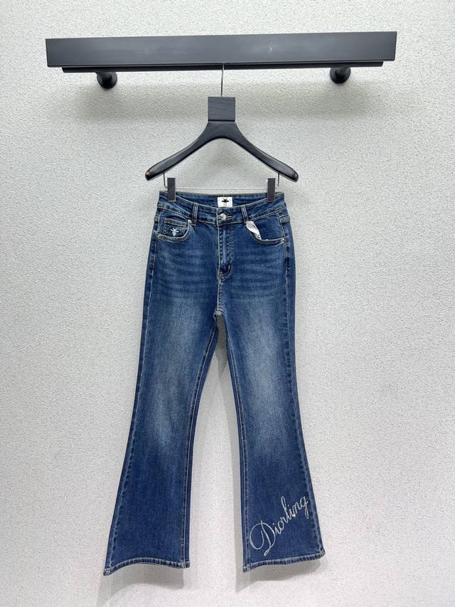 D brand rhinestone lettered flared denim trousers with Dior logos on the front a