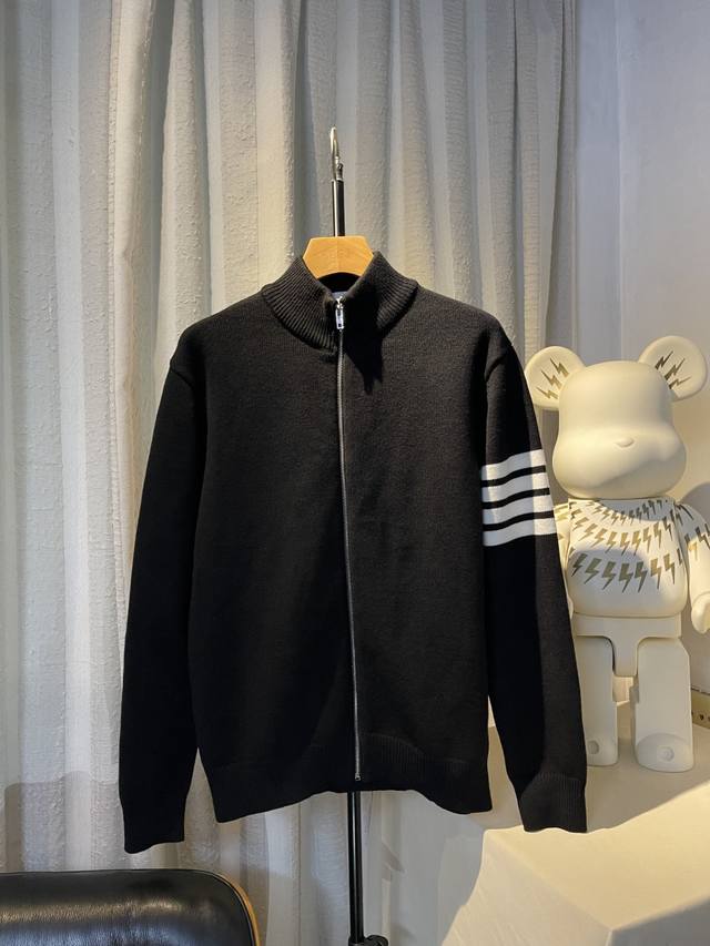 Hanging photo detail: logo jacquard knit craftsmanship. Ddd's simple silhouette