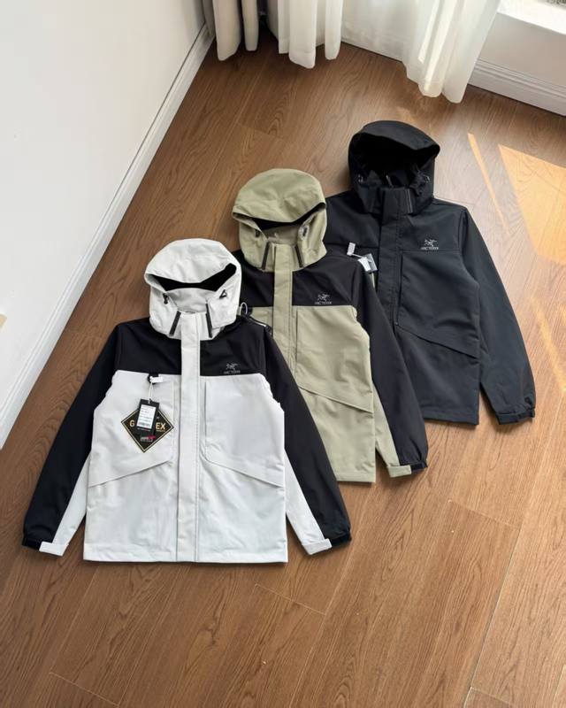 Arc'Teryx Tri-Proof Outdoor Jacket. Waterproof hood, detachable multi-pocket zip