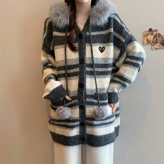Play Comme des Gar?ons ( Rei Kawakubo) Help! This striped cardigan from Comme de