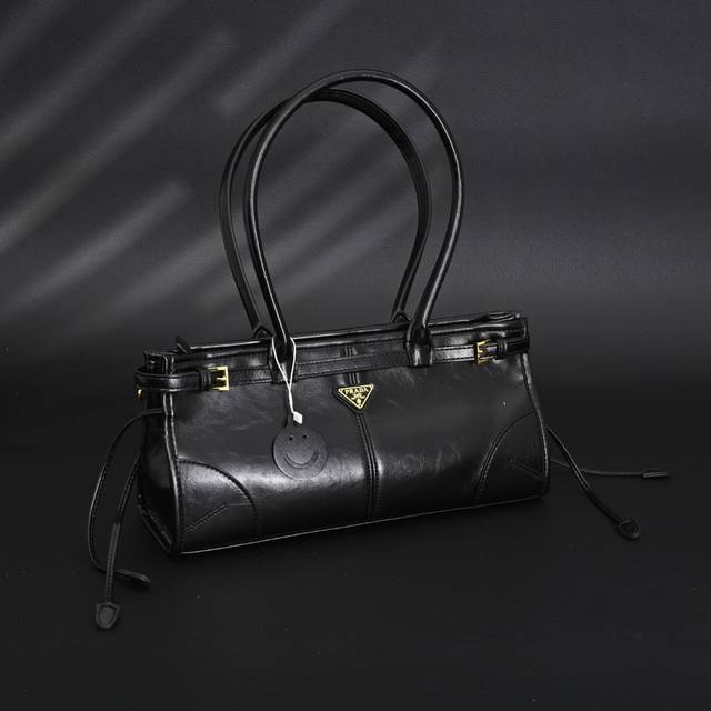 Prada Soft Lux Medium Handbag. A perfect blend of chic and vintage style, this b