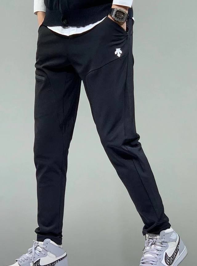 Descente Men's Fleece-Lined Woven Softshell Sports Pants. The woven fabric surfa