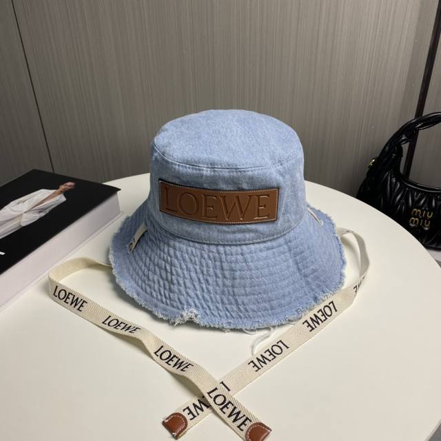 Comes with dust bag. Loewe's unique bucket hat with a strap; extremely hard to f Comes with dust bag. Loewe's unique bucket hat with a strap; extremely hard to f
