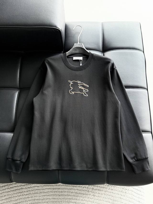 Clothing. Haute couture Burberry design. Features a logo with rhinestones on the