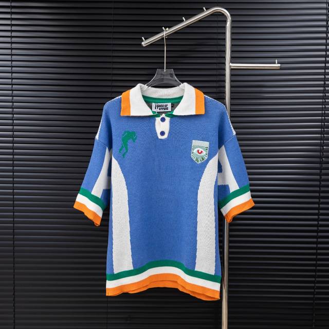 Style: House Of Errors British designer brand eyeball-themed patchwork knit polo