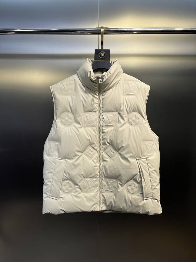Louis Vuitton's classic and timeless short down vest system. A versatile piece s