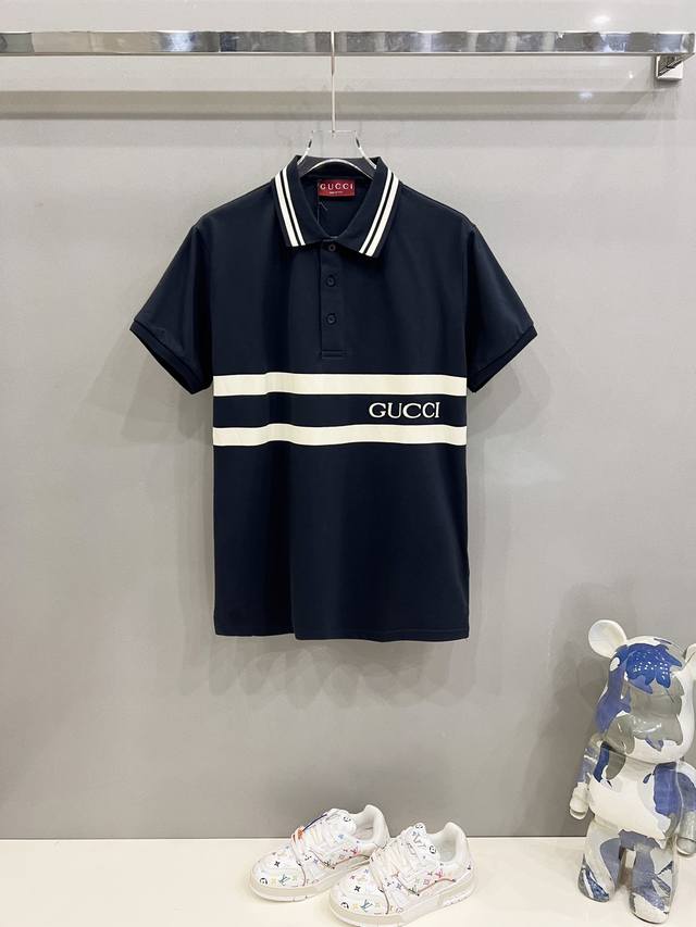 Gucci Polo Shirt with Color Block Stripes, Lettering, and Brand Logo Print. Offi