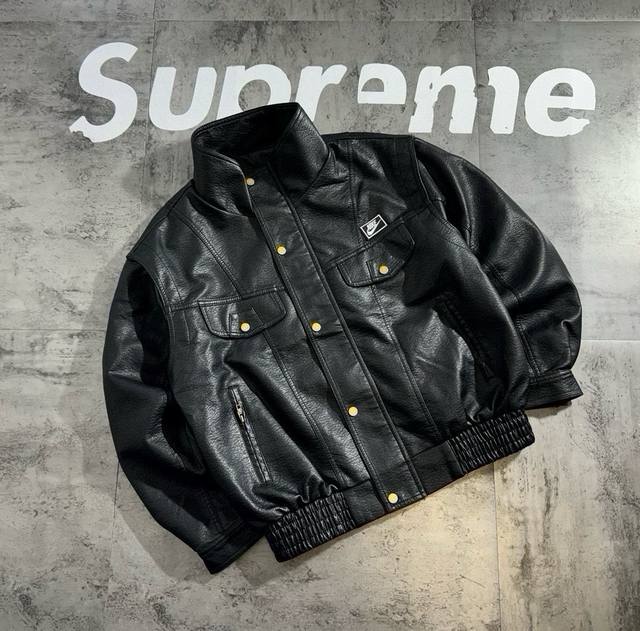 Nike's signature cut and patchwork leather jacket with a stand-up collar featur