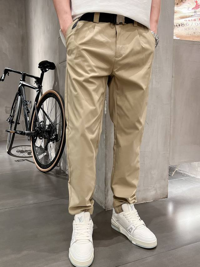 pra25Ss cotton blend casual trousers with metal buckle waistband. Men's stylish