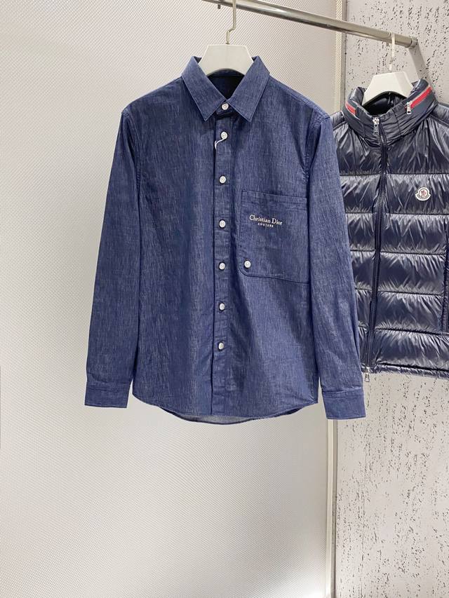 D. Blue denim shirt with embroidered logo. Made by OEM factory p. Made from 100%