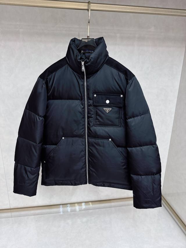 Prada's new down jacket with a metal logo. Made from Re-Lon recycled nylon, thi