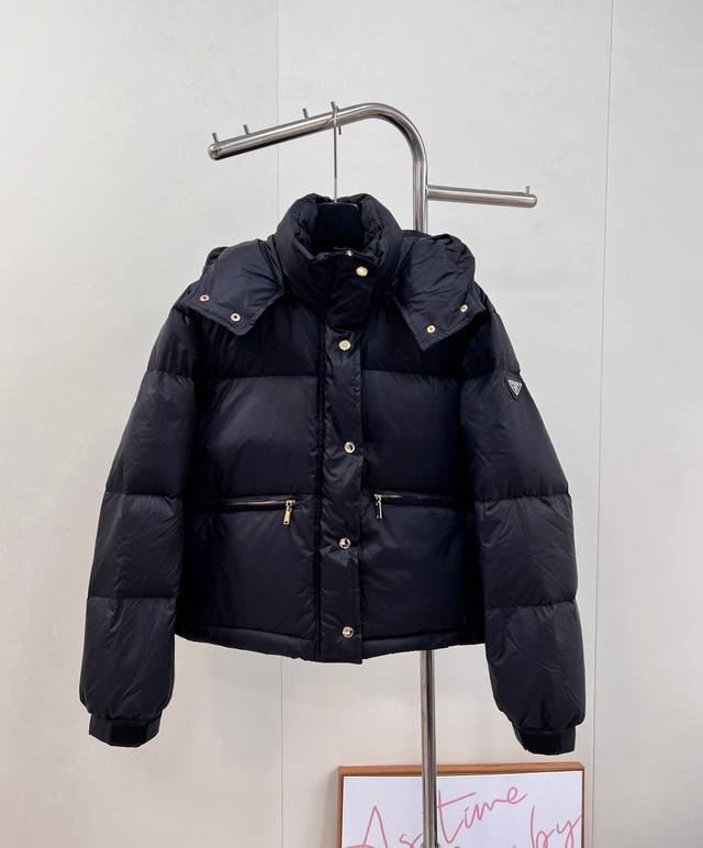 prad25Fw Autumn/Winter Triangle Logo Hooded Down Jacket. The metal buckle at the