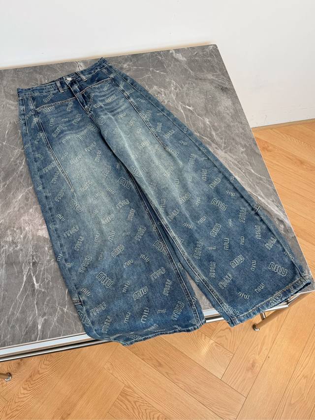 Blue jeans with a cool and edgy vibe. The all-over Miu Miu logo print is highly