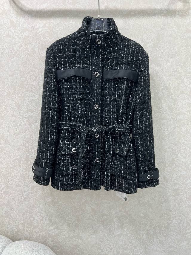 Chan*L This 25K black tweed jacket features a classic Chanel-inspired design wit